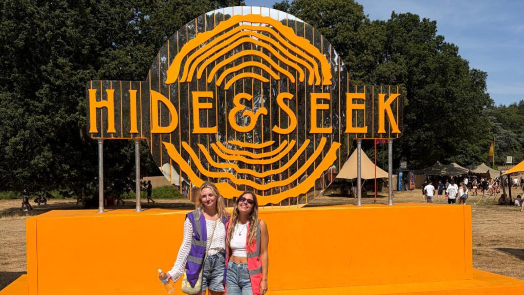 Kaboodle staff in front of Hide& Seek festival logo